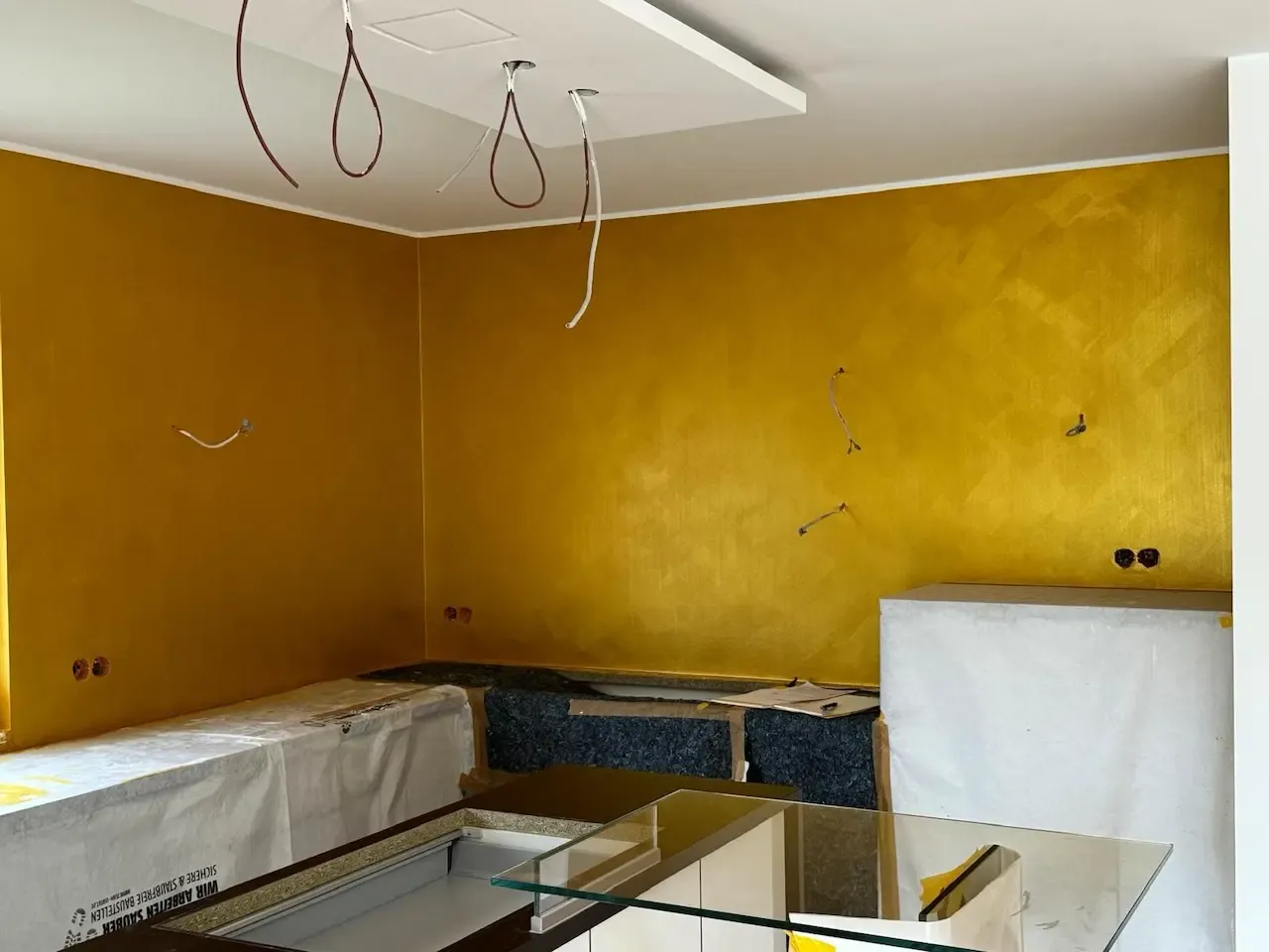 Elegante goldene Wandgestaltung in der Küche: Eine hochwertig vergoldete Wand in einer neu renovierten Küche, die von farbDESIGN und WERKstatt umgesetzt wurde. Die leuchtenden Akzente verleihen dem Raum eine warme und exklusive Atmosphäre.